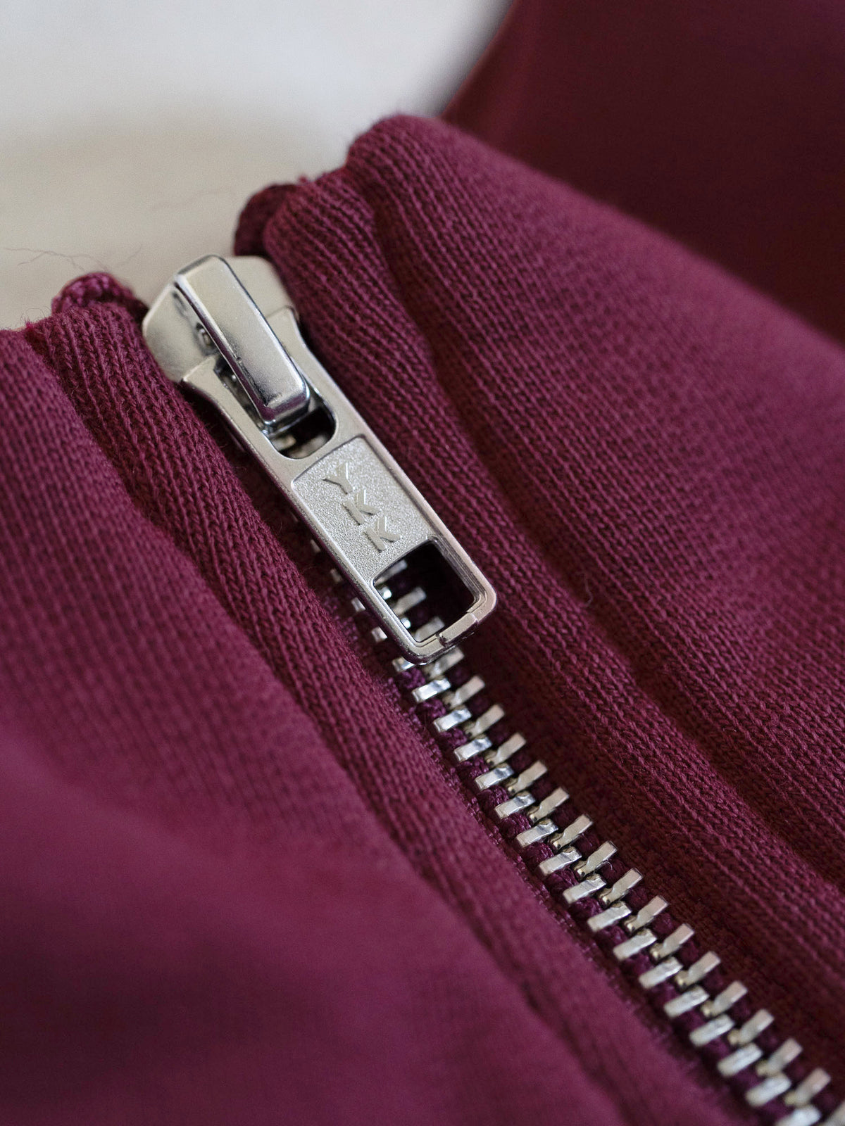 Detailansicht YKK Reißverschluss an FUXBAU Half Zip Sweater aus GOTS-zertifizierter Bio-Baumwolle – langlebig und fair hergestellt in Portugal.