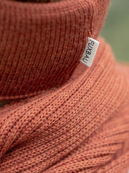 GOTS zertifiziertes Stirnband von FUXBAU in Herbstorange. Gefertigt unter fairen Bedingungen in Deutschland aus extra feiner und weicher Merino Schurwolle.
